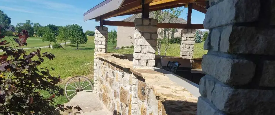 Outdoor living space with a kitchen, seating area and pergola at a home in Lincoln, NE. 